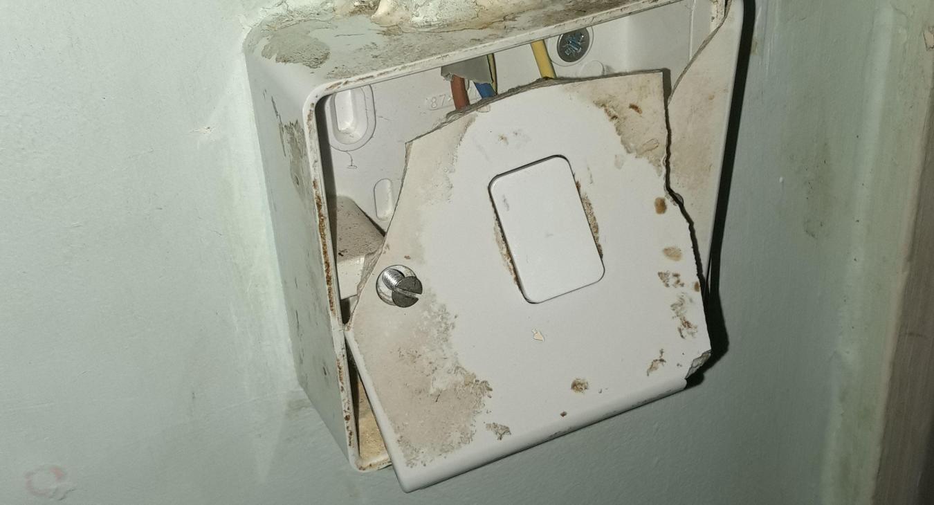 Angry tenant loved punching light switches as found by EICR electrician conducting report for electrical safety risk