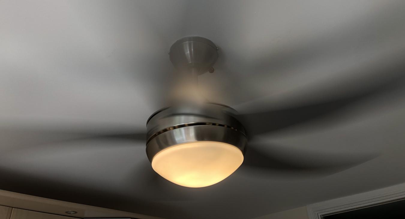 chatham electrician putting smart ceiling fan light with remote control up