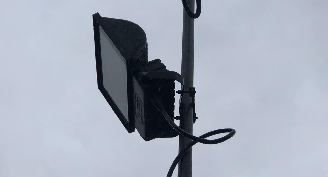 commercial electrician looks at commercial grade LED floodlight in Rochester, Kent