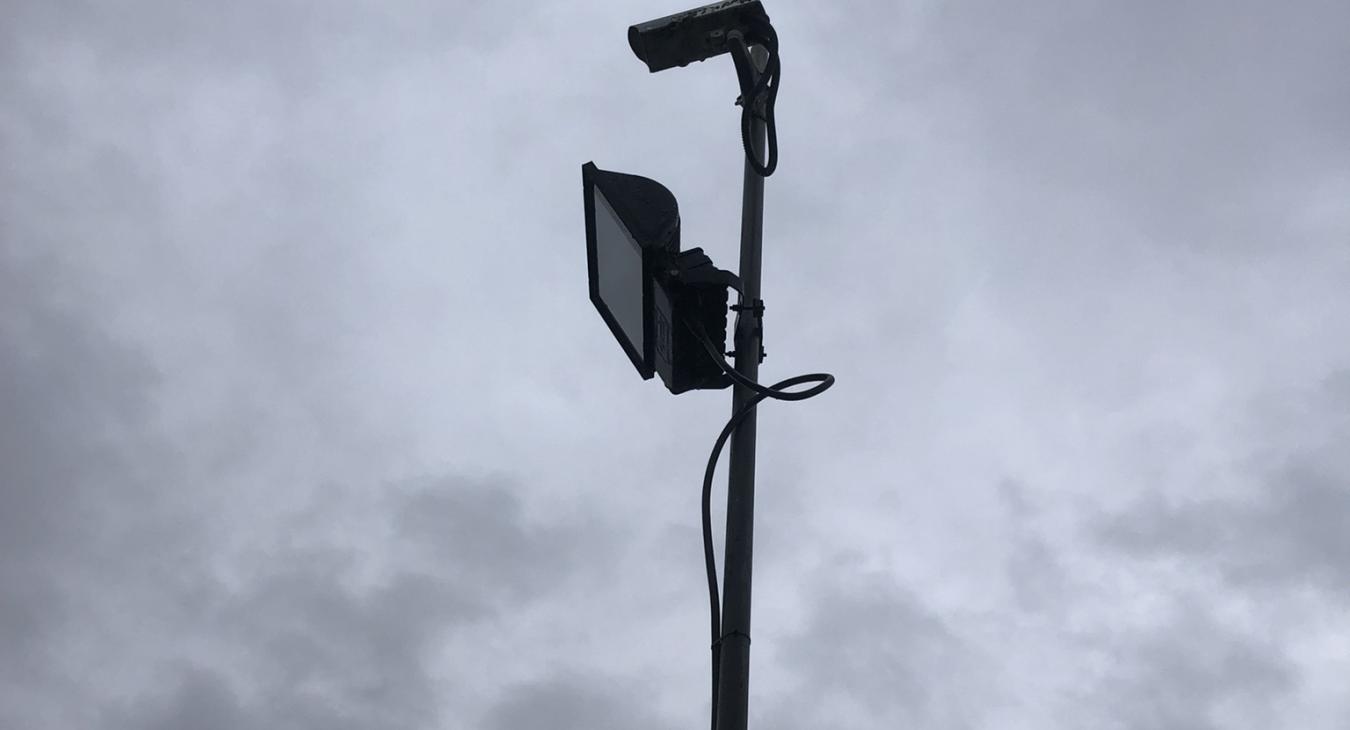 commercial electrician looks at high power LED floodlight in Rochester, Kent