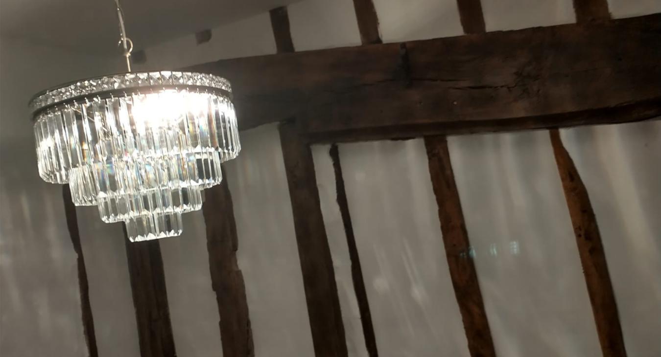 small job electrician in Medway fits chandelier above a stairwell in a beautiful grade II listed building in Bearsted, Maidstone