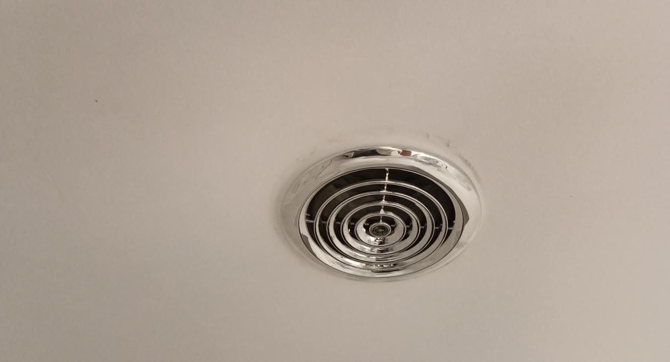 The only part you have to see in the bathroom, a lovely chrome grille on the ceiling