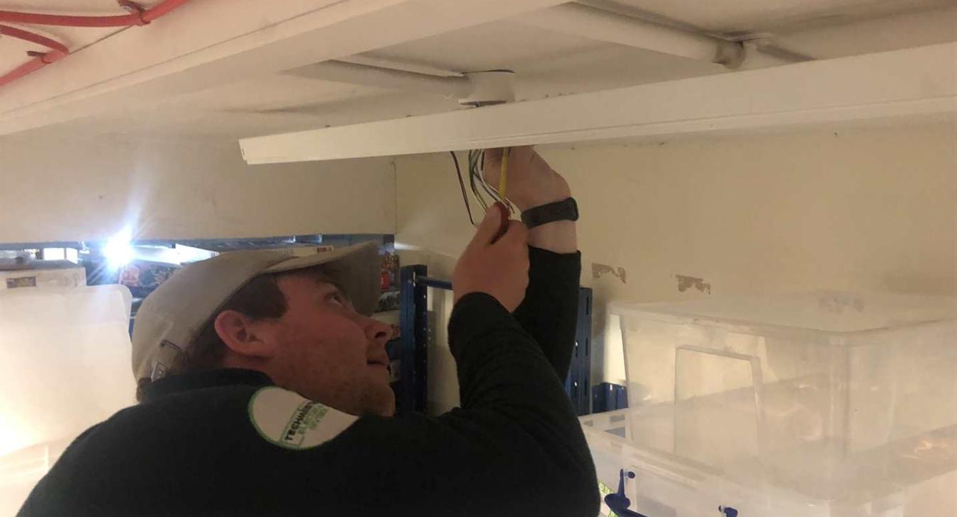 commercial electrician replacing fluorescent lights
