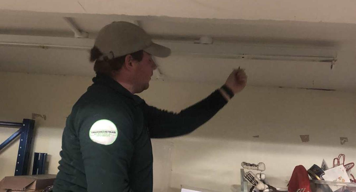 Retail electrician changing faulty light